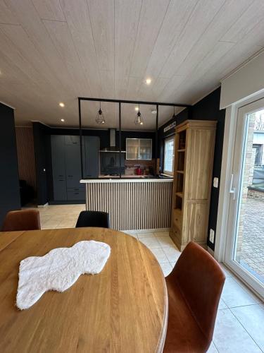 a kitchen with a wooden table with chairs and a dining room at The175 work or holiday home in Comines