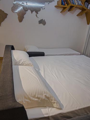 a bedroom with two beds with a world map on the wall at Appartamento Principe in Monterosso al Mare