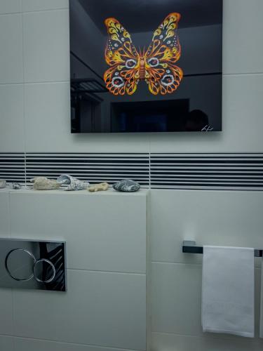 a picture of a butterfly hanging on a wall at Appartamento Principe in Monterosso al Mare