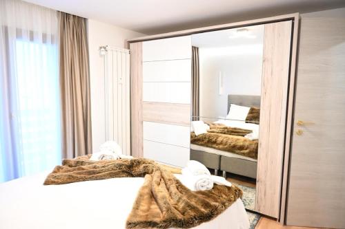 a bedroom with two beds and a mirror at Crans Montana - regent school in Lens