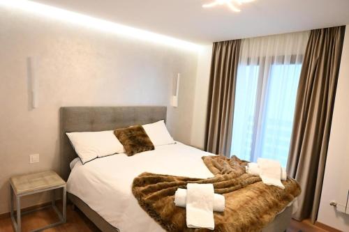 a bedroom with a large bed with a furry blanket at Crans Montana - regent school in Lens