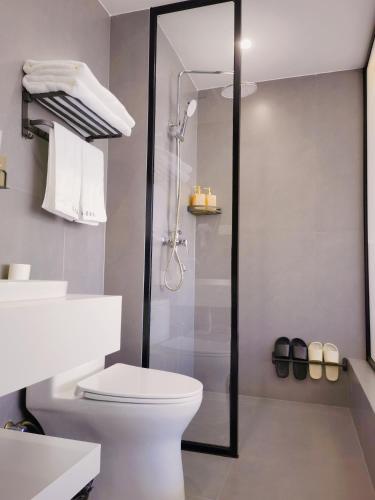 a bathroom with a shower and a white toilet at 大理顾里海景别墅Dali Guli Sea View Villa Hotel in Dali