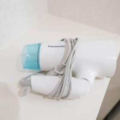 a hair dryer sitting on top of a box at Mutsumi Konohana 601 むつみ庵此花 601 in Osaka