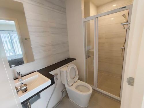 a bathroom with a toilet and a sink and a shower at 1 Bedroom condo next to Central Hatyai in Hat Yai