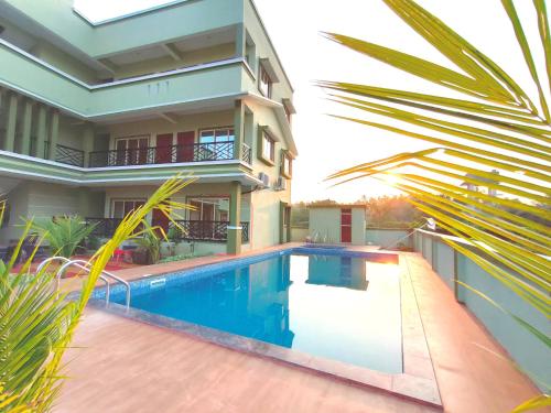 a house with a swimming pool in front of a house at ILIF 2726 Beach Haven in Nāgaonkhar