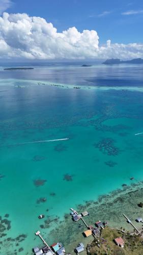 an aerial view of a large body of water at Bigfin water bungalow in Semporna