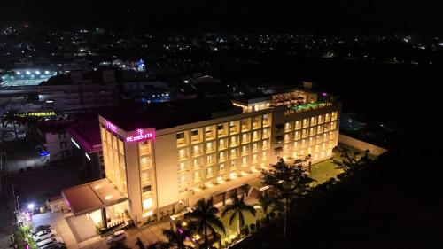 a large building with lights on it at night at Regenta Dehradun by Royal Orchid Hotels Limited in Dehradun