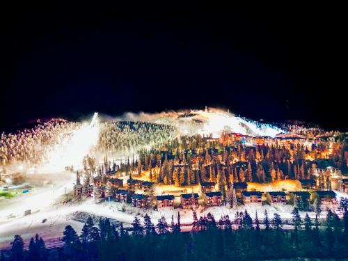 a group of buildings on a ski slope at night at Lomakivakka - Roomy 2BD & loft by the lake, free wifi and sauna in Ruka