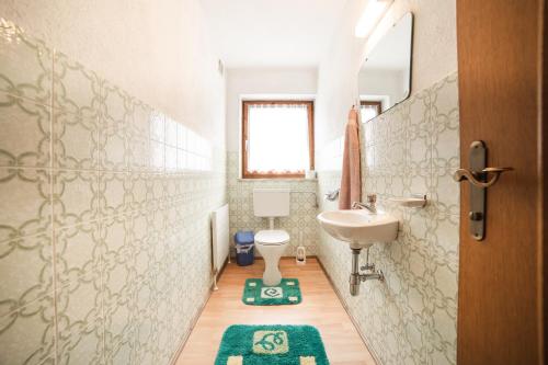 a bathroom with a sink and a toilet at Ferienhaus Oberanger in Kaltenbach