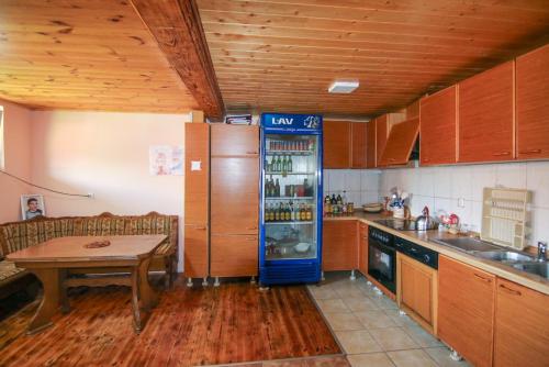 a kitchen with a refrigerator and a table in it at Country Villa MMMM-3-Camp Scepanovic in Mojkovac