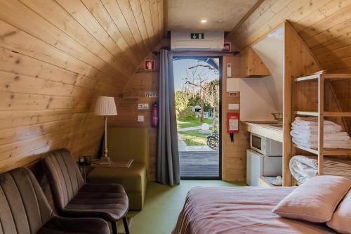 a room with a bed and a chair in a room at Villam Vale da Estrela in Guimarães