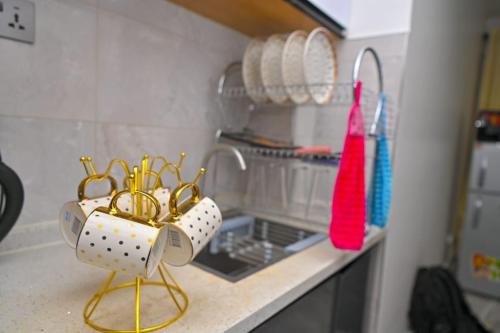 a kitchen counter with dishes and utensils on it at Nicestay Homes in Nairobi