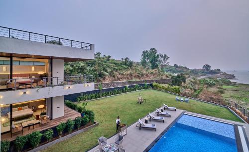an aerial view of a house with a swimming pool at SaffronStays Eldora by the Lake in Matheran