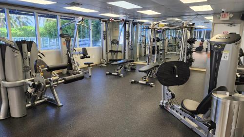 a gym with a bunch of treadmills and machines at Stunning Beachfront condo in sunny Sunny Isles Beach with AC, fitness room, WiFi in Sunny Isles Beach
