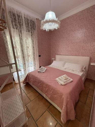 a bedroom with a bed with two towels on it at MG Luxury Home in Naples