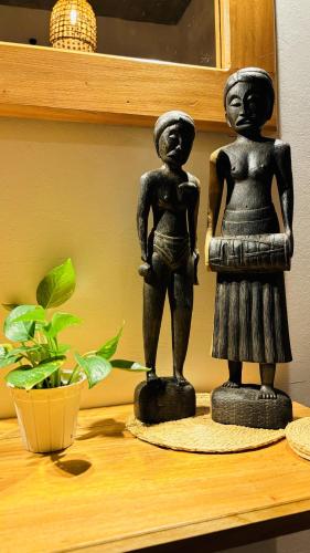 two black statues sitting on top of a shelf at Mount Side Hiriketiya in Hiriketiya