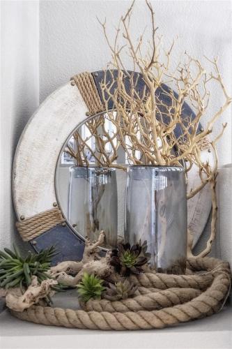 a wicker basket with two glasses and a mirror at Blue Pacific in Fort Bragg