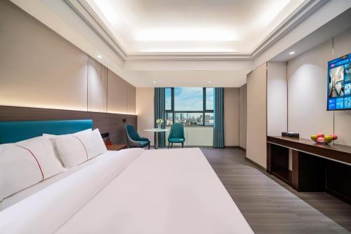 Postel nebo postele na pokoji v ubytování Mei Gang Hotel