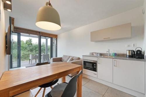 a kitchen and dining room with a table and chairs at Studio Deluxe | 2 Pers. Landzijde in Ouddorp