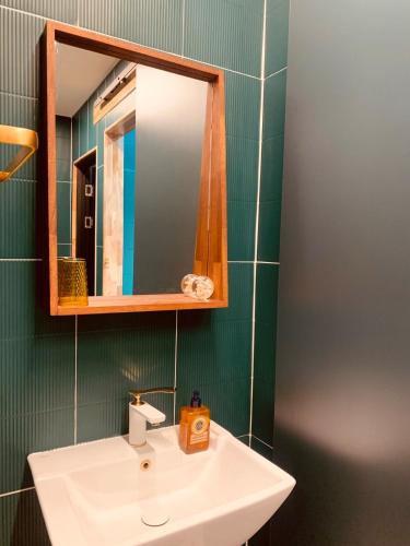 a bathroom with a white sink and a mirror at Im Youngchon in Gangneung