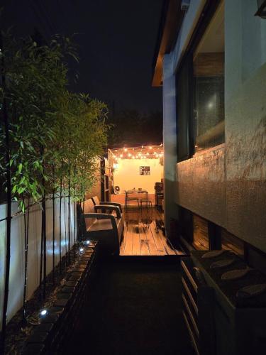 a patio at night with a table and chairs at Im Youngchon in Gangneung