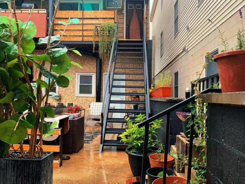 a stairway with plants and a staircase in a building at BRICK CITY VILLA! 20 minutes from NYC in Newark