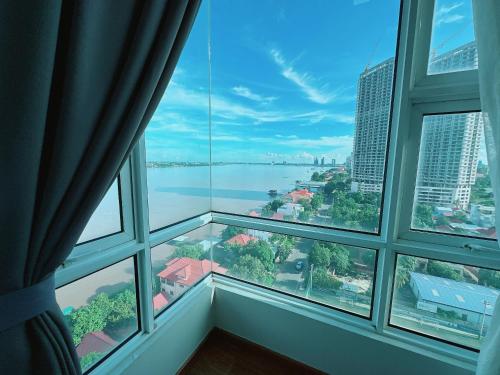 a window with a view of the city and water at Infinity 28 Hotel and Residence in Phnom Penh