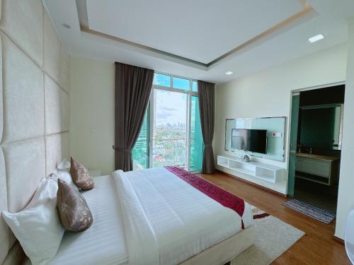 a bedroom with a large bed and a television at Infinity 28 Hotel and Residence in Phnom Penh