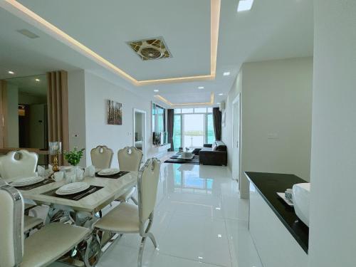 a dining room and living room with a table and chairs at Infinity 28 Hotel and Residence in Phnom Penh