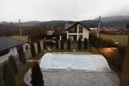 an aerial view of a house with a tennis court at VIP House in Mykulychyn