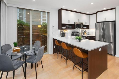 a kitchen with a table and chairs and a refrigerator at Perch - Centro House A in Seattle