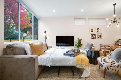 a living room with a bed and a tv at Perch - Ballard Bliss in Seattle