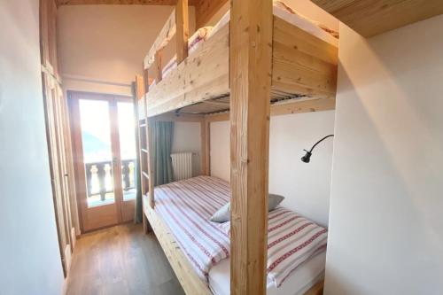 a bunk bed room with two bunk beds and a window at Roxes 6 in Bagnes
