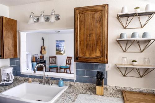 a kitchen with a sink and a mirror at Sea La Vie in Fort Bragg