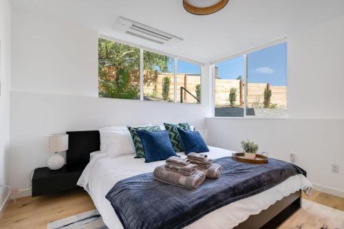 a bedroom with a large bed with blue pillows at Perch - View Ridge Guest Suite in Seattle