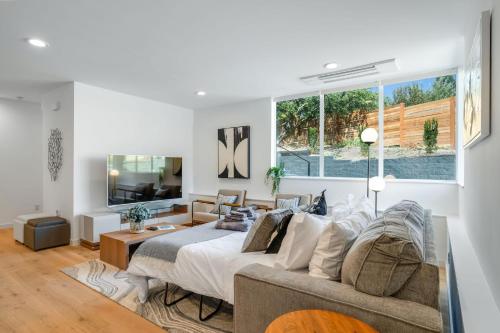 a bedroom with a bed and a living room at Perch - View Ridge Guest Suite in Seattle