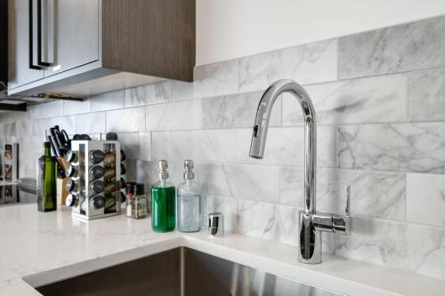 a kitchen sink with a faucet on a counter at Perch - View Ridge Guest Suite in Seattle