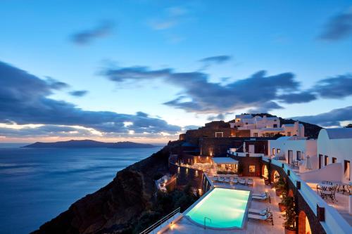 a view of the amalfi coast at dusk at San Antonio - Small Luxury Hotels of the World in Imerovigli
