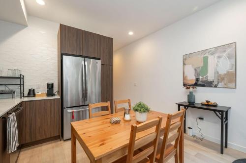 a kitchen and dining room with a wooden table at Perch - Sand Point Haven in Seattle