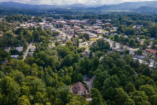 an aerial view of a town in the midst of trees at Brevard Basecamp in Brevard