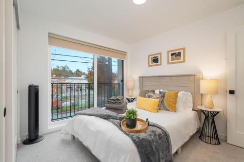 a bedroom with a bed and a large window at Perch - Sand Point Haven in Seattle
