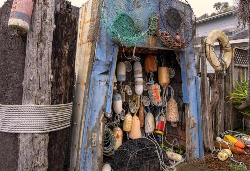 a wooden door with a bunch of different types of items at Boat House in Fort Bragg