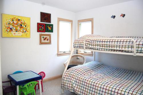 a bedroom with two bunk beds and a bed at M906- Castle De La Mar in Corolla