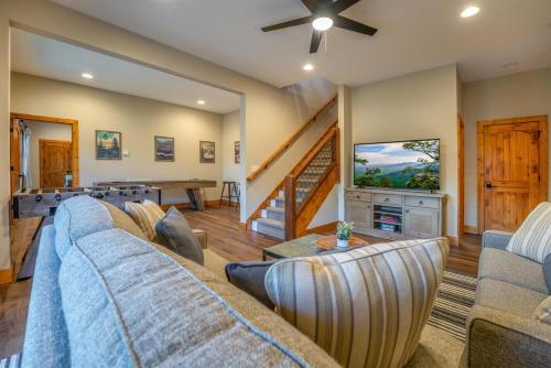 a living room with a couch and a table at Canopy Creek Connestee Falls in Brevard