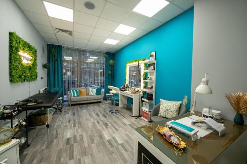 an office with blue walls and a desk and chairs at Iceberg Apartment 50 in Borovets