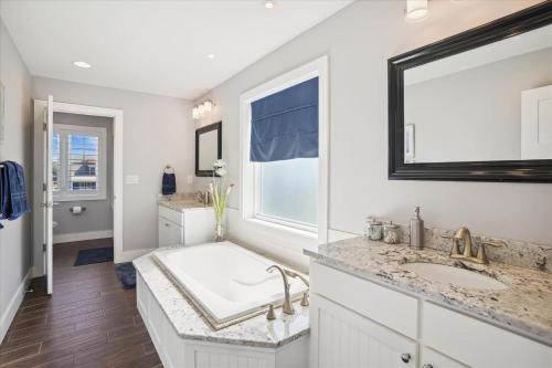 a white bathroom with two sinks and a window at CH219C - Southern Jewel in Kill Devil Hills
