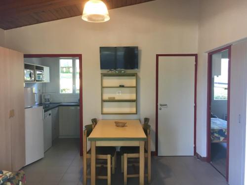 a kitchen and dining room with a table and chairs at Résidence de Tourisme LE VENDAHAUT in Lapleau