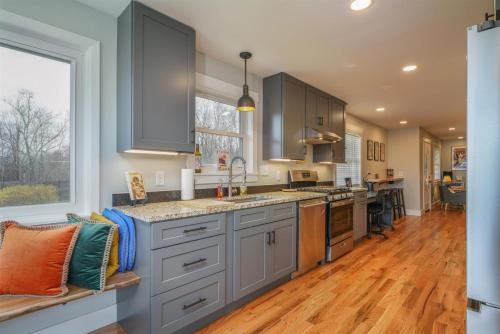 a kitchen with gray cabinets and a large window at JB`s Place in Brevard