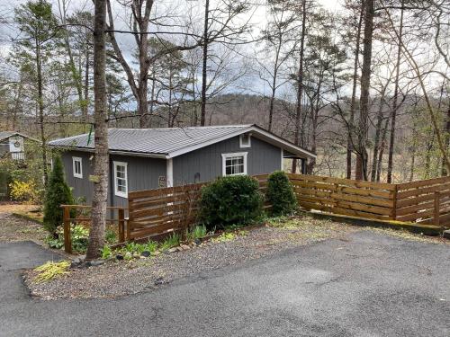 a small house in the woods with a wooden fence at New Listing! Two Houses - 4 Minutes to Dahlonega in Dahlonega