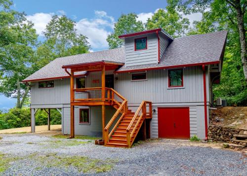 a house with a red door and a wooden staircase at Sweet Refrain in Pisgah Forest